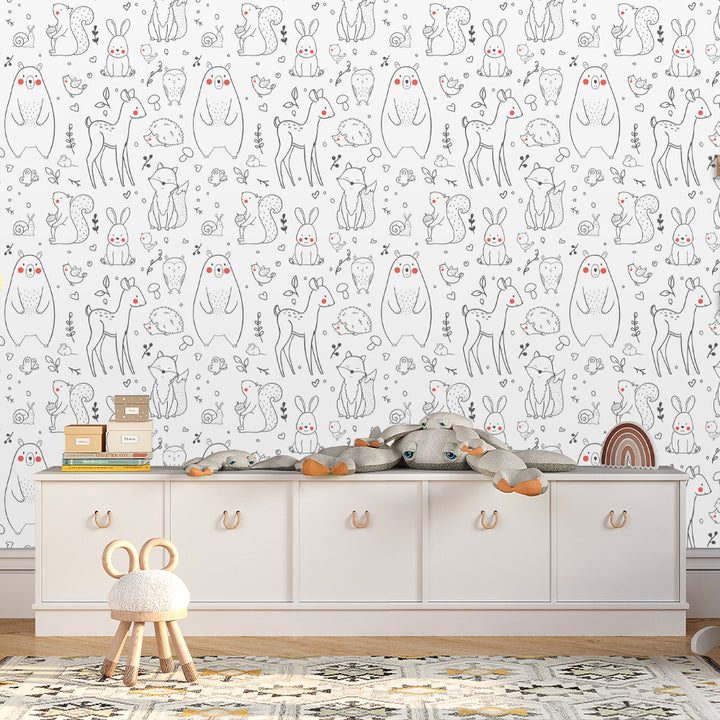 Scandinavian woodland wallpaper with black and white hand-drawn forest animals and blush pink details, perfect for modern nursery décor and easy installation using removable peel-and-stick wallpaper.